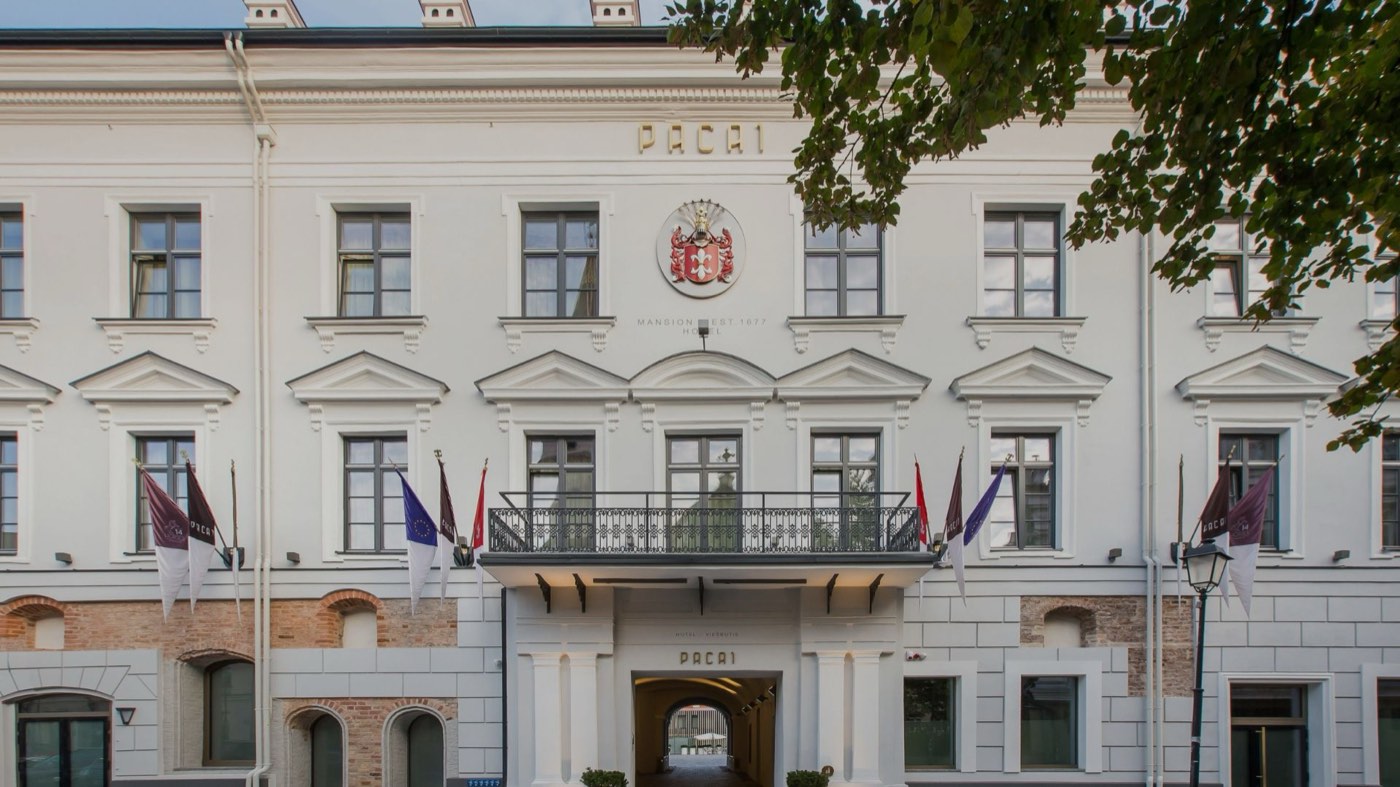The white facade of Hotel PACAI on Didžioji Street in Vilnius Old Town